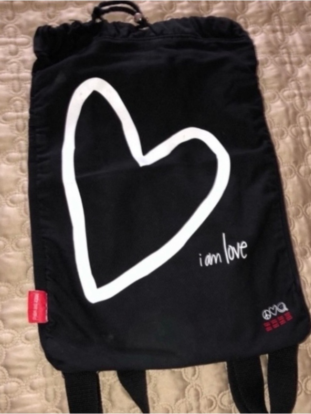 Black Drawstring Backpack with White Heart and "i am love" Graphic